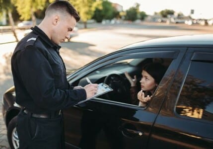 A police officer writing a speeding ticket.