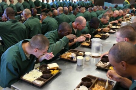 Prisoners eating inside a federal prison.
