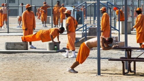 Prisoners working out inside a federal prison.