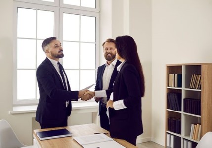 Client shaking hands with their attorney.
