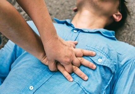 A good Samaritan giving CPR.