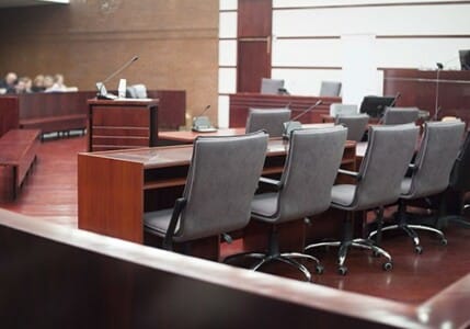 Inside a courtroom with the jury in the background.