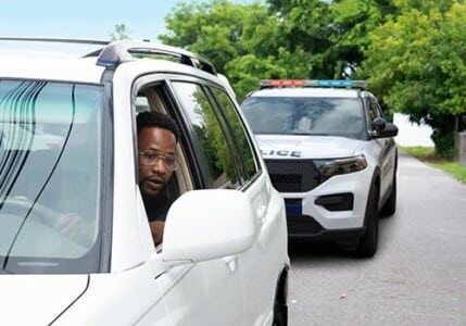 A man being pulled over by the police for a traffic stop.