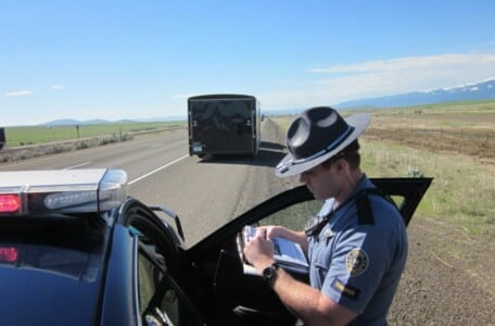 A police officer writing a speeding ticket.
