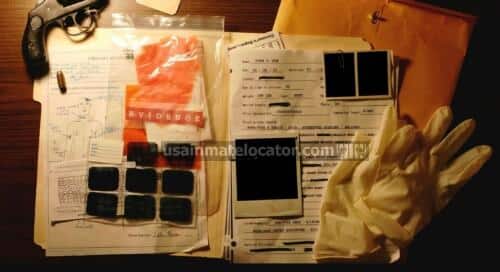 A cold case folder surrounded by other evidence including photographs and rubber gloves.
