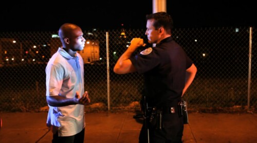 A man being detained for questioning.